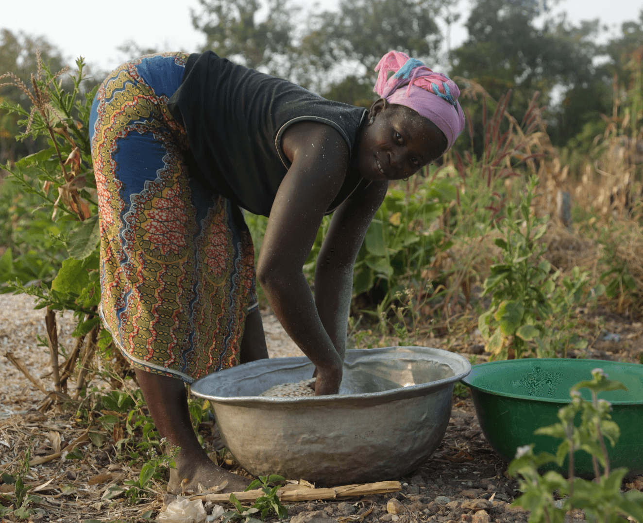 A woman working with crops in West Africa